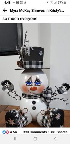 a snowman sitting on top of a wooden table