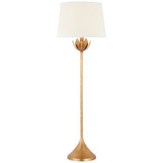 a gold lamp with a white shade on it