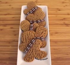 a white plate topped with cookies on top of a wooden table