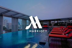 the marriot hotel logo is displayed in front of a swimming pool with red lounge chairs