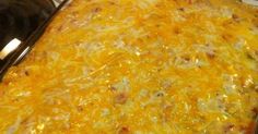 a casserole dish with cheese and other toppings in a pan on the stove