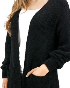 Black Knit Fuzzy Cardigan | Black Fuzzy Cardigan Your closet’s newest favorite cardi! Introducing the oversized Fuzzy Knitted Cardigan - the perfect cardigan that’s anything but basic. With fuzzy textured soft midweight yarn, this cardi gives you an easy layer to style whether you dress it up or down! Why you’ll love it: Oversized black knit cardigan with textured eyelash yarn Soft, cozy feel, with front functional patch pockets and slight lantern sleeve The perfect layering piece to style now a Cozy Everyday Cardigan, Cozy Fit Soft Knit Everyday Cardigan, Cozy Solid Cardigan For Layering, Soft Texture Everyday Winter Cardigan, Black Chunky Knit Outerwear For Layering, Black Textured Knit Cardigan For Winter, Black Textured Knit Winter Cardigan, Knit Cardigan With Soft Texture For Layering, Black Soft Knit Everyday Outerwear