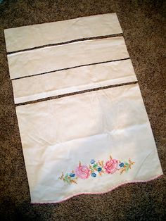 a piece of white cloth with pink flowers on it