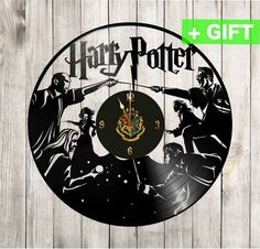 harry potter vinyl record clock with hogwarts and hermigania on it