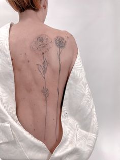 the back of a woman's body with flowers on it