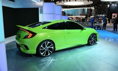 a bright green sports car on display at an auto show