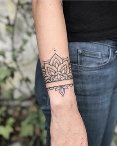 a woman's arm with a tattoo on it and a flower in the middle