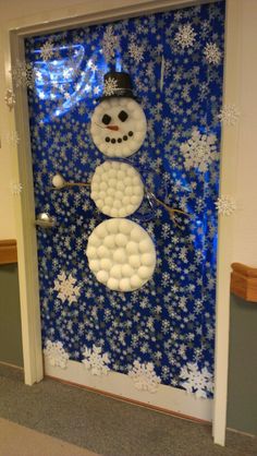 a snowman made out of balloons on a door