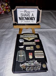 there is a sign that says please share a memory next to some badges and pins