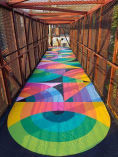 the walkway is painted with colorful designs on it