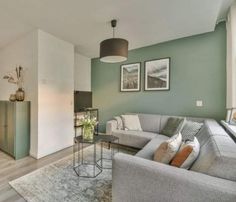 a living room filled with furniture and green walls