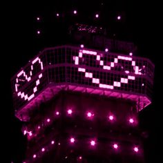 the eiffel tower is lit up with pink lights