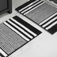 two black and white rugs sitting on top of a counter