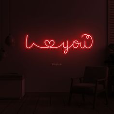 a red neon sign that says i love you in the middle of a dark room