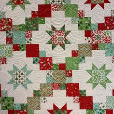 a red and green christmas quilt with stars on it's sides, all in different colors