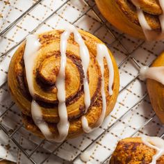 cinnamon rolls with icing on a cooling rack