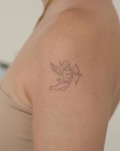 a woman with a small tattoo on her shoulder