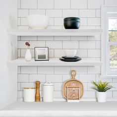 white shelves with black and white dishes on them