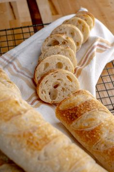 some bread rolls are sitting on a towel