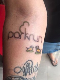 a close up of a person's arm with tattoos on it and the words parkun