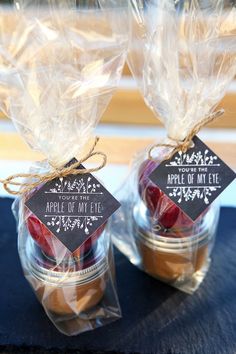 two small jars filled with food on top of a table