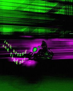 a person riding a motorcycle in the dark with neon lights on it's side