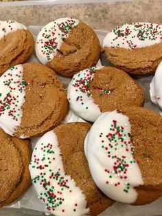 there are many cookies with white frosting and sprinkles