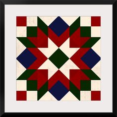 an abstract quilt design in red, green, and blue with black frame on the wall