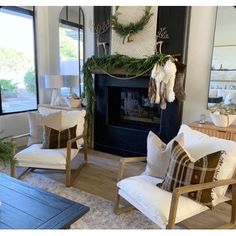 a living room filled with furniture and a fire place in front of a large window