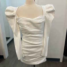 the back of a white dress on a mannequin