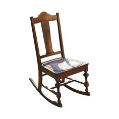 a wooden rocking chair with white and blue fabric on the seat, against a white background