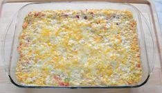 a casserole dish with cheese and other toppings in a glass baking pan