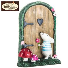 a white mouse standing in front of a wooden door with flowers and hearts on it