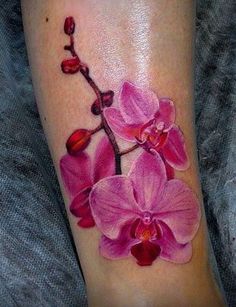 a close up of a person's foot with a flower tattoo on the leg