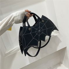 Complete your Gothic-inspired outfit with this adorable bat wings mini sling bag! Perfect for Halloween parties! Made of high-quality vegan leather, this beautifully crafted backpack has extra zipper pockets inside and outside of the sling bag to better safe-keep your belongings. Material: Vegan Leather Lining Material: Polyester Size: Length: 20-34cm (7.87" - 13.3"); Height: ~20cm (7.87"); Width: 7cm (2.75") Shoulder Strap Length: Approximately 120cm (47.2") Click ADD TO CART To Order Yours Now! The Checkout Process is Guaranteed to be 100% Safe and Secure with Visa, Mastercard, AMex, Discover, Apple Pay or PayPal. Black Zipper Closure Shoulder Bag For Halloween, Edgy Halloween Party Bags, Gothic Leather Bags For Halloween, Black Shoulder Bag For Halloween Cosplay, Black Leather Halloween Bags, Sac Halloween, Gothic Bag, Purse Trends, Goth Accessories