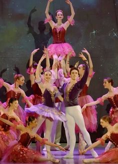 a group of ballerinas standing on top of each other