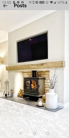 a living room with a fireplace and tv mounted on the wall