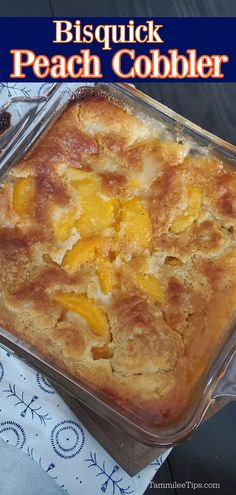 a casserole dish with peach cobbler in it on a blue and white tablecloth