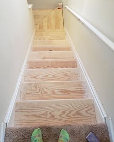 someone is walking up the stairs with their feet on the carpeted steppads