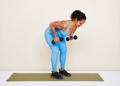 a woman in blue doing exercises with dumbbells