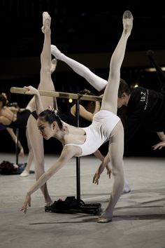 two ballet dancers performing on the floor