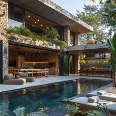 an outdoor living room and dining area next to a swimming pool