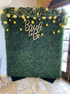 a green wall with yellow flowers and the words bride to be written on it