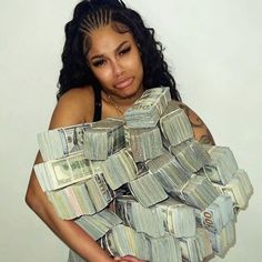 a woman holding stacks of money in her arms