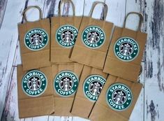 six brown paper bags with starbucks logos on them