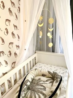 a baby crib with an animal themed curtain