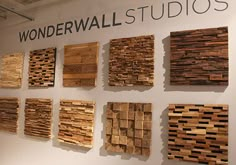 several pieces of wood are displayed on the wall in front of a sign that says wonderwall studios