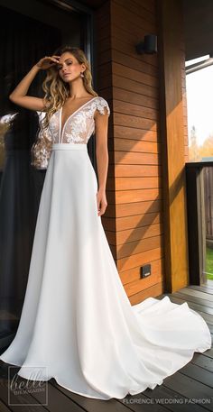 a woman in a white dress standing on a porch