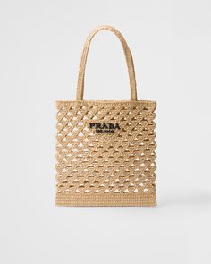 Raffia-effect yarn Crochet handles Lettering logo embroidered on the front Unlined interior Crochet Logo, Crochet Handles, Prada Tote Bag, Bag Prada, Handmade Crochet Bags, Crochet Tote Bag, Woven Raffia, Crochet Tote, Triangle Logo