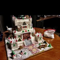 an elaborate gingerbread castle sits on a table